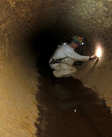 Man working inside pipe